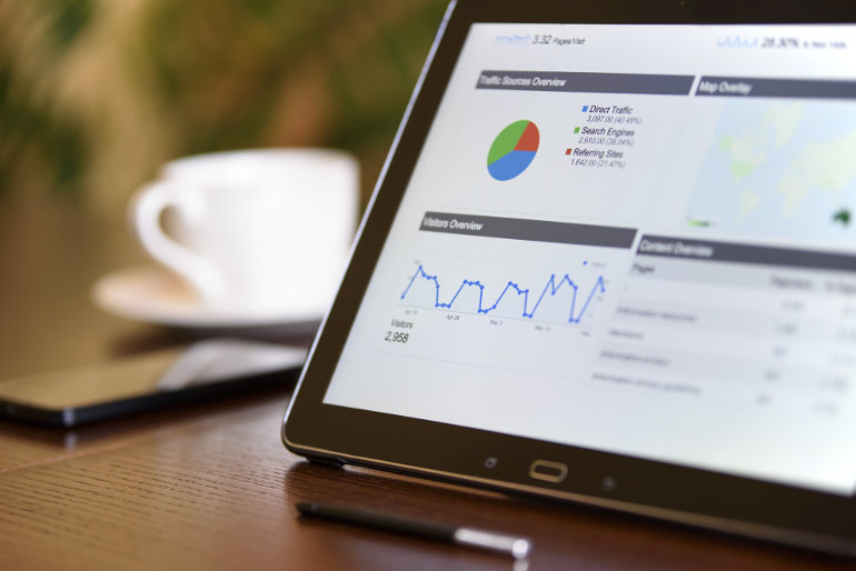 Data displayed on a tablet in the form of a pie chart, line graph, map, and data table.