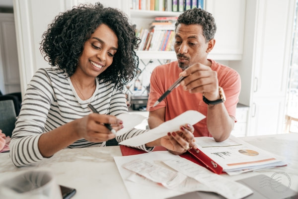 A couple preparing their state income tax return together at home.